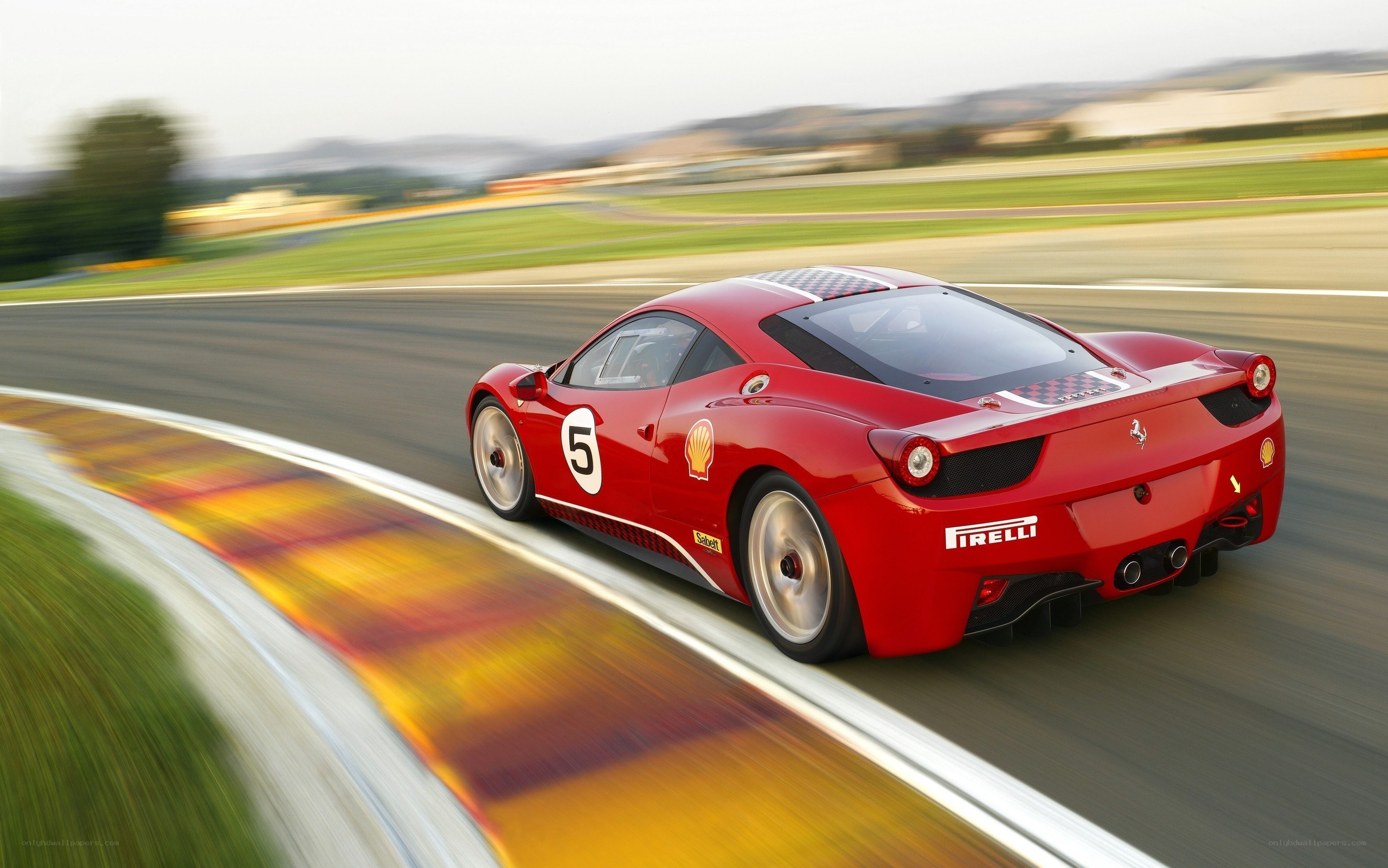Red Ferrari racing on track