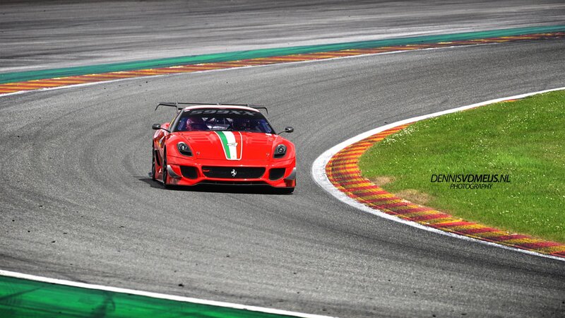 Red Ferrari racing on track