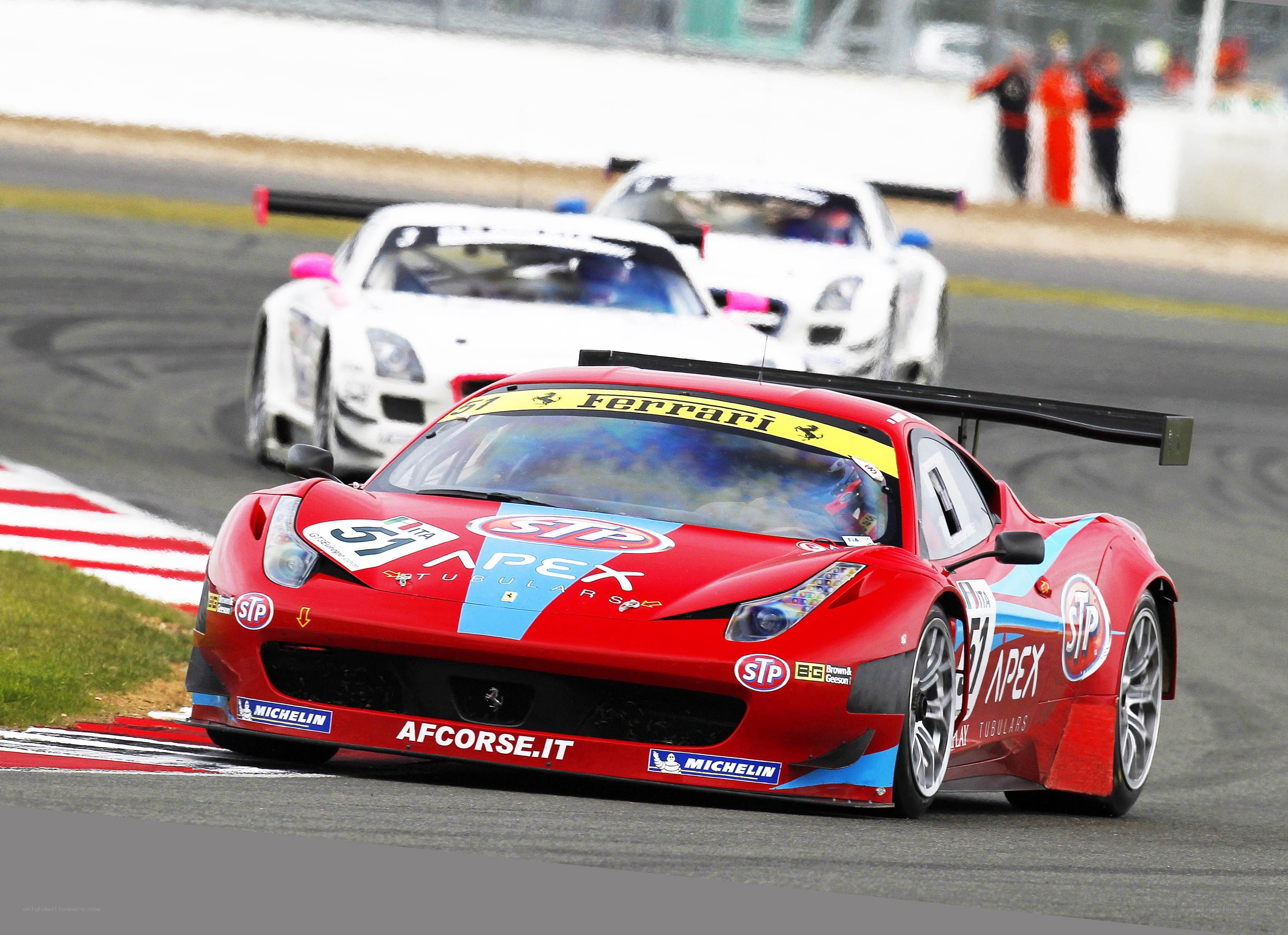 Red Ferrari racing on track