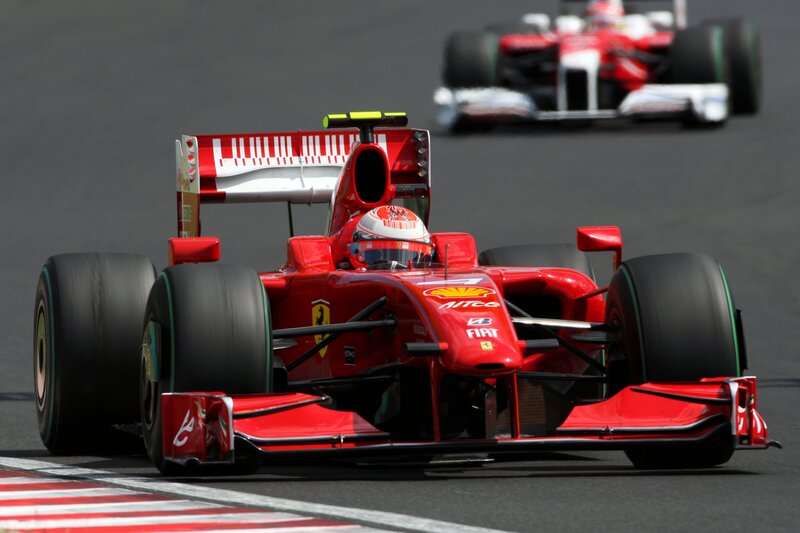 Red Ferrari racing on track