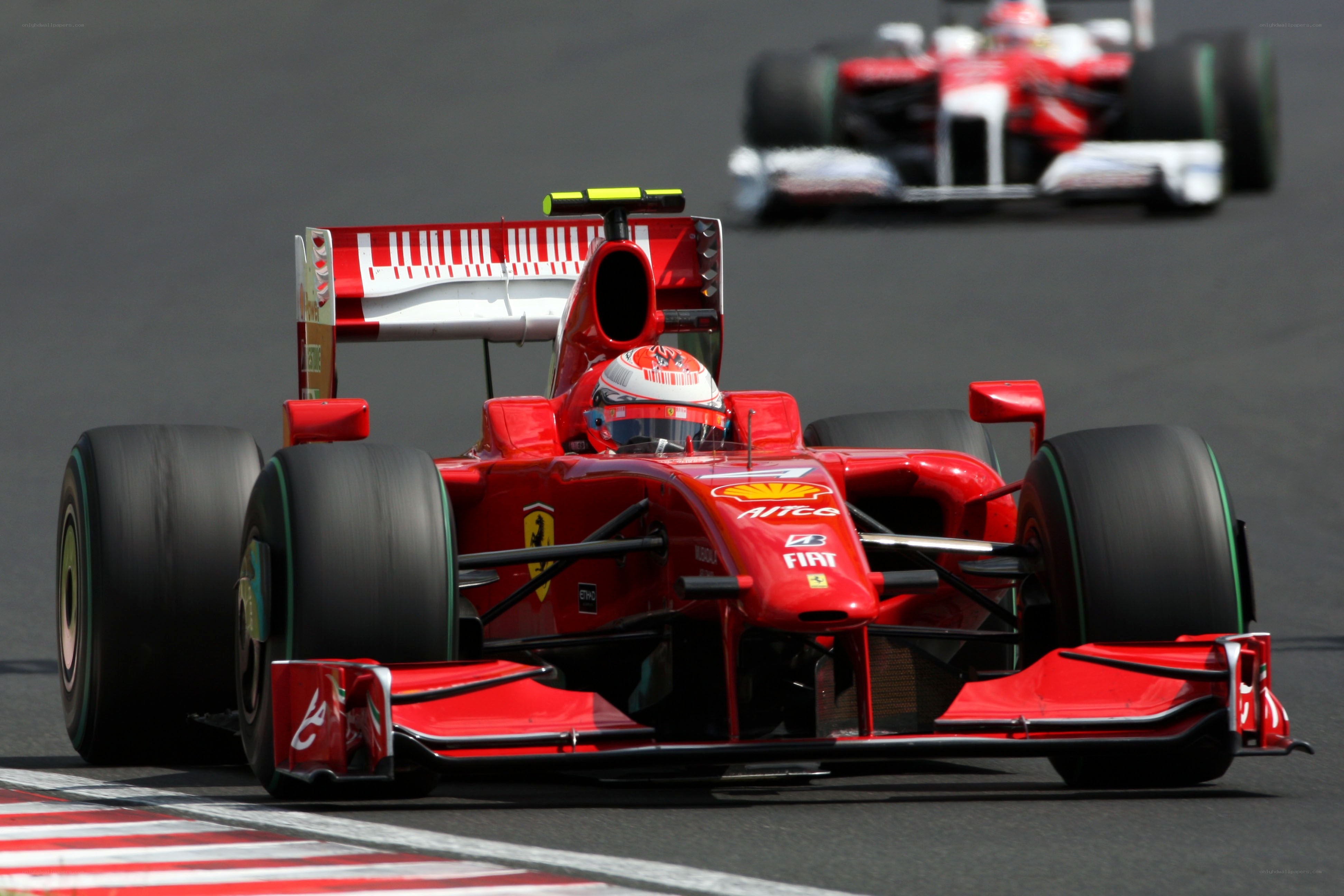 Red Ferrari racing on track