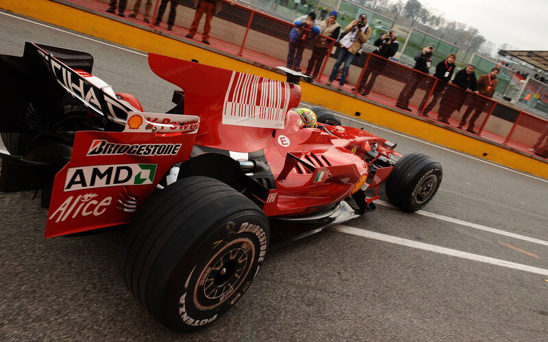 Red Ferrari racing on track