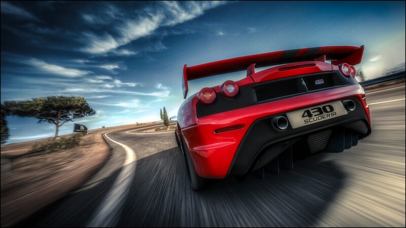 Red Ferrari Scuderia on a winding road