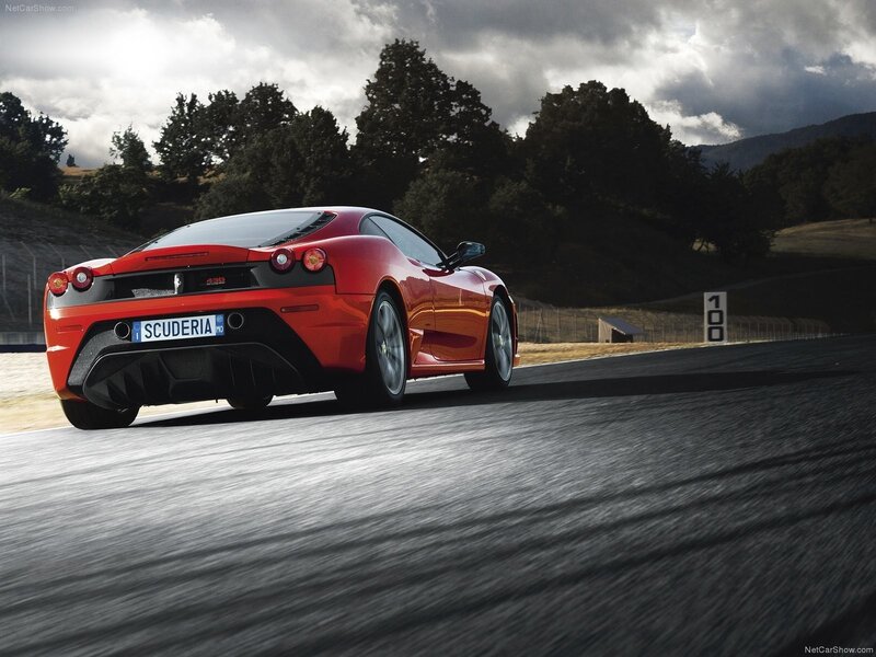 Red Ferrari Scuderia on racetrack