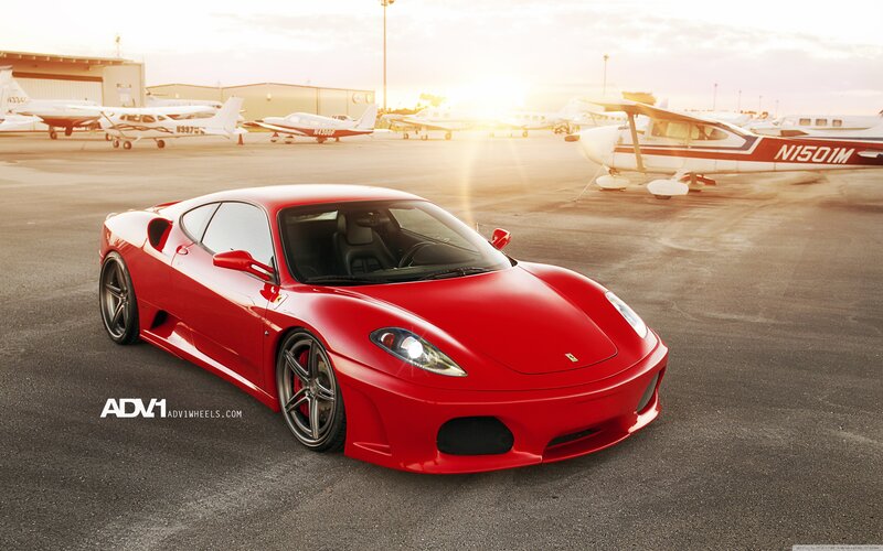 Red Ferrari Sports Car — Airport