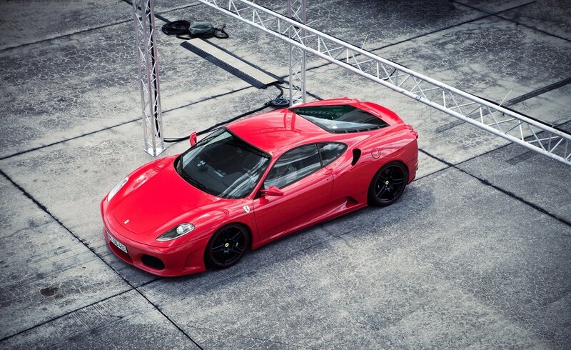 Red Ferrari Sports Car — Dramatic, Photograph, Concrete Surface