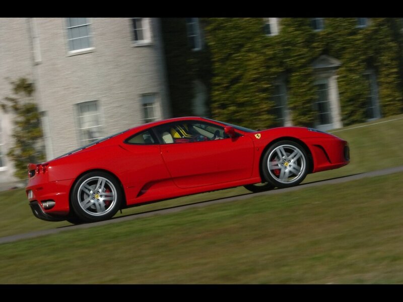 Red Ferrari Sports Car — Dynamic, Afternoon, Photograph, Building, Grass