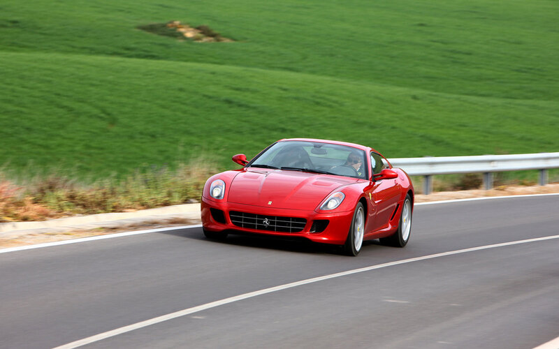 Red Ferrari Sports Car — Dynamic, Afternoon, Photograph, Driver, Road, Guardrail, Green Field