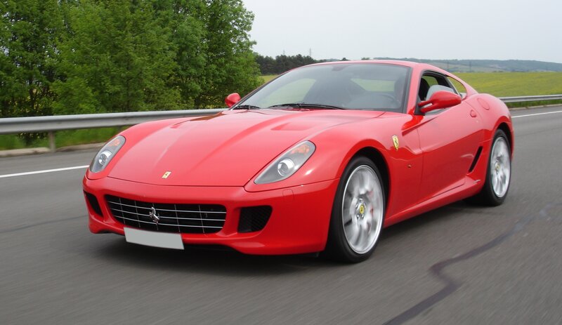 Red Ferrari Sports Car — Dynamic, Afternoon, Photograph, Road, Trees, Guardrail, Gray, Green