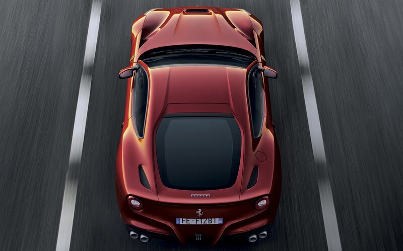 Red Ferrari sports car in motion