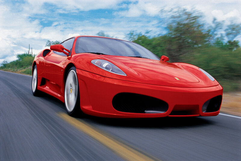 Red Ferrari sports car in motion
