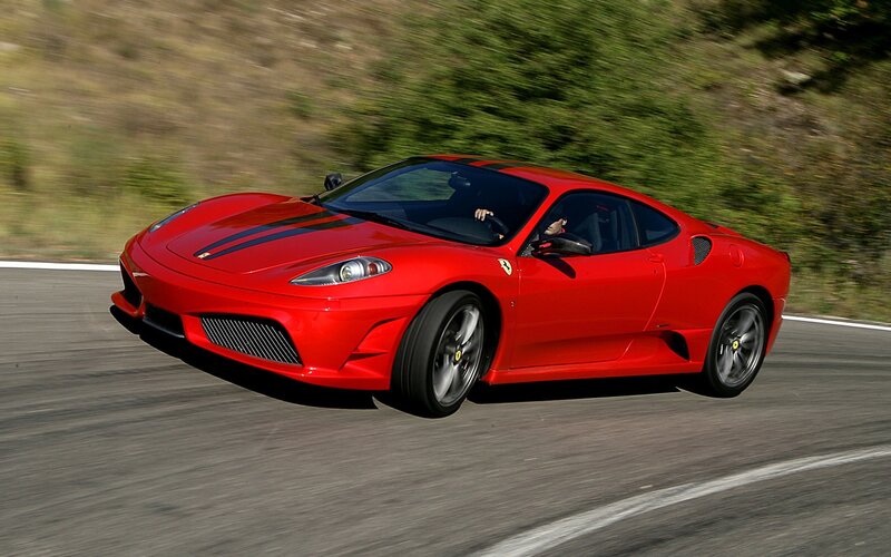 Red Ferrari sports car in motion