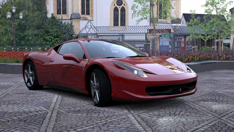 Red Ferrari sports car on cobblestones