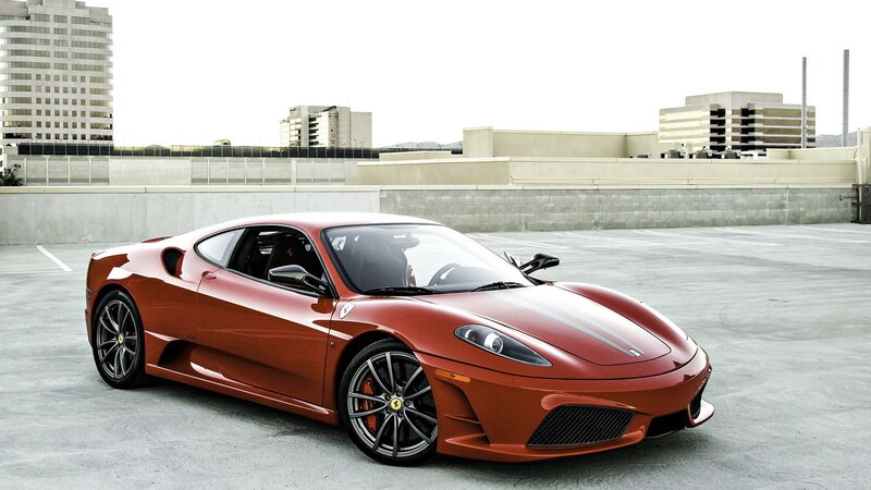 Red Ferrari sports car on rooftop