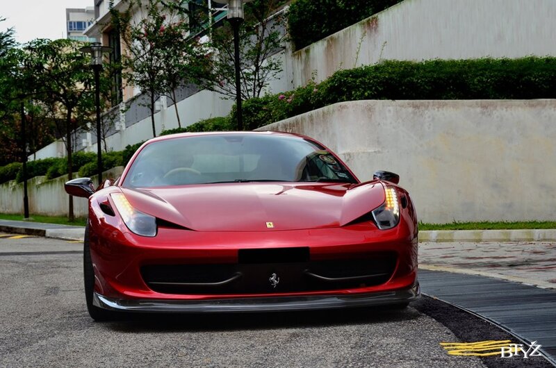 Red Ferrari sports car on street