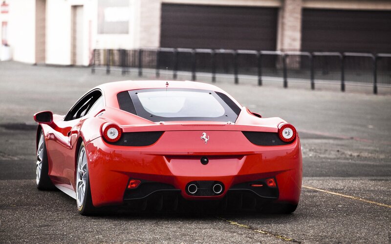 Red Ferrari sports car rear view