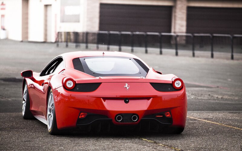 Red Ferrari sports car rear view