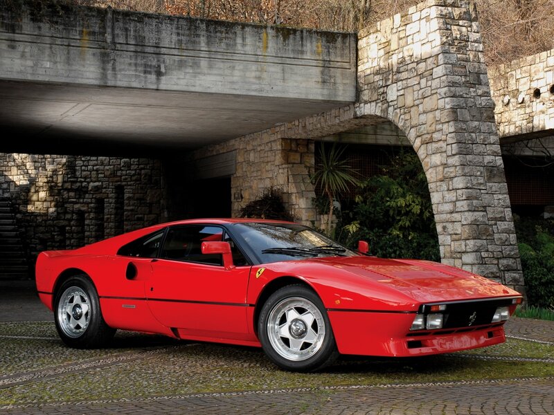 Red Ferrari sports car under bridge