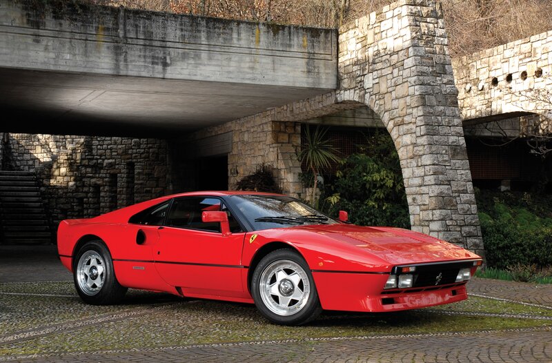 Red Ferrari sports car under bridge