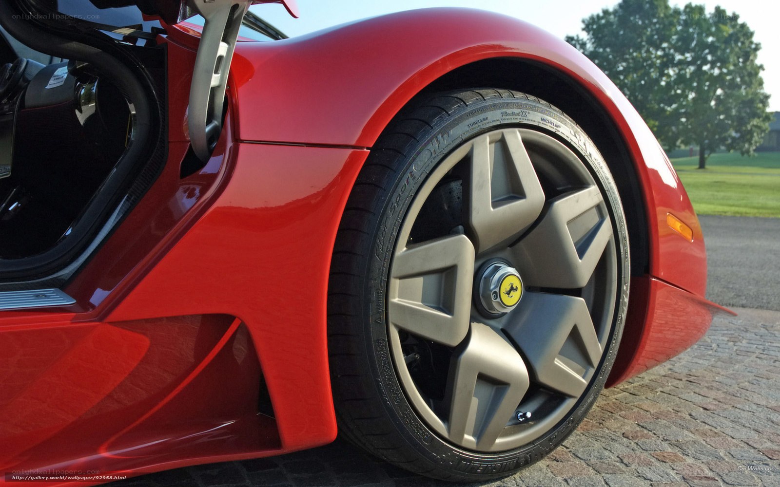 Red Ferrari sports car wheel