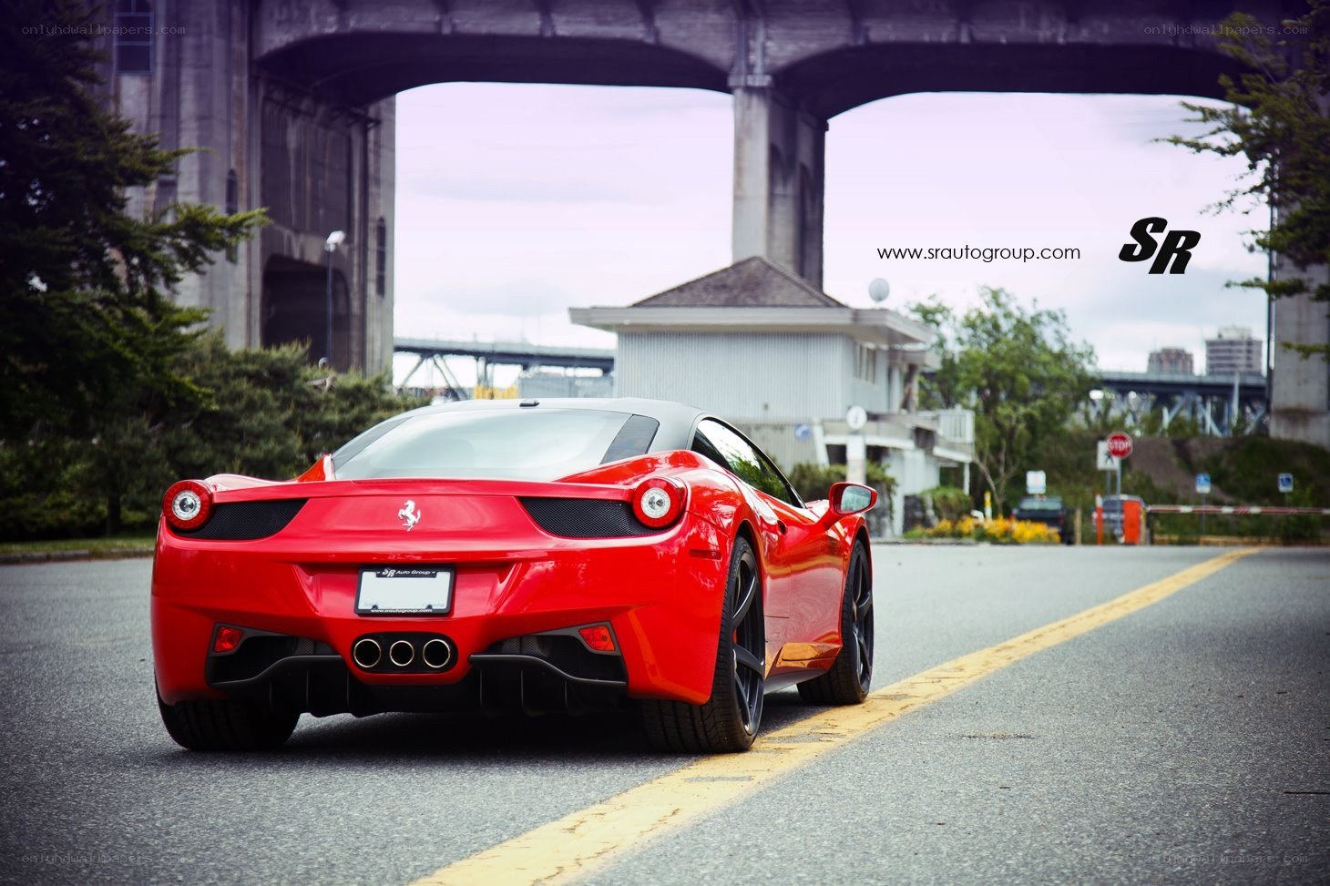 Red Ferrari under a bridge