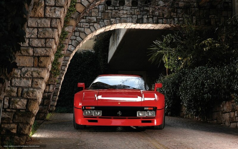 Red Ferrari under stone arch