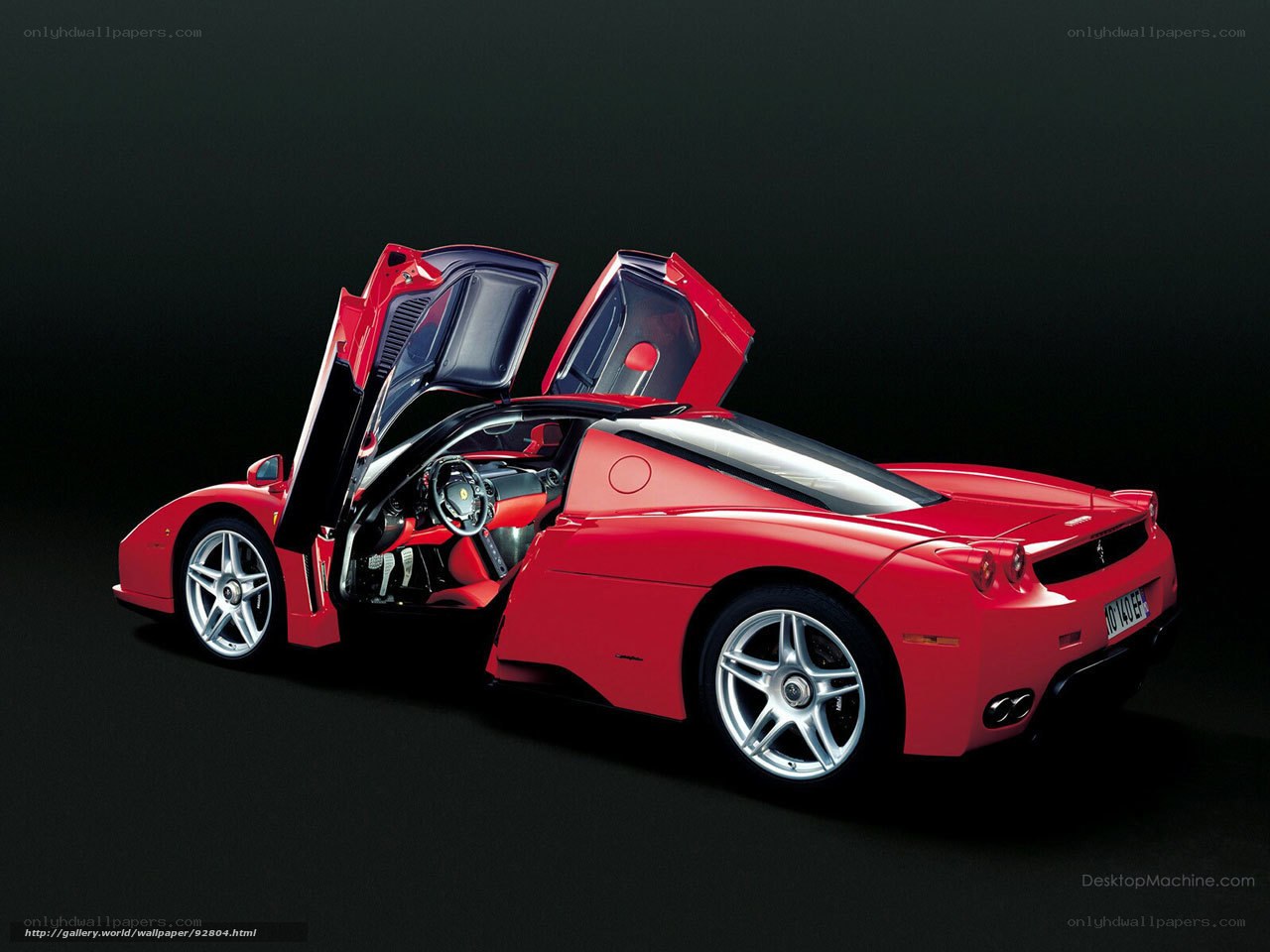 red ferrari with doors open