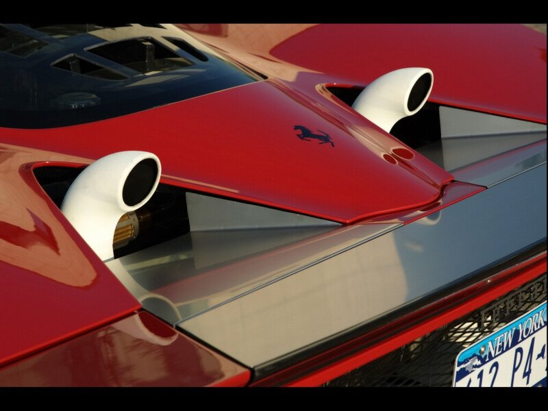 Red Ferrari with exhaust pipes