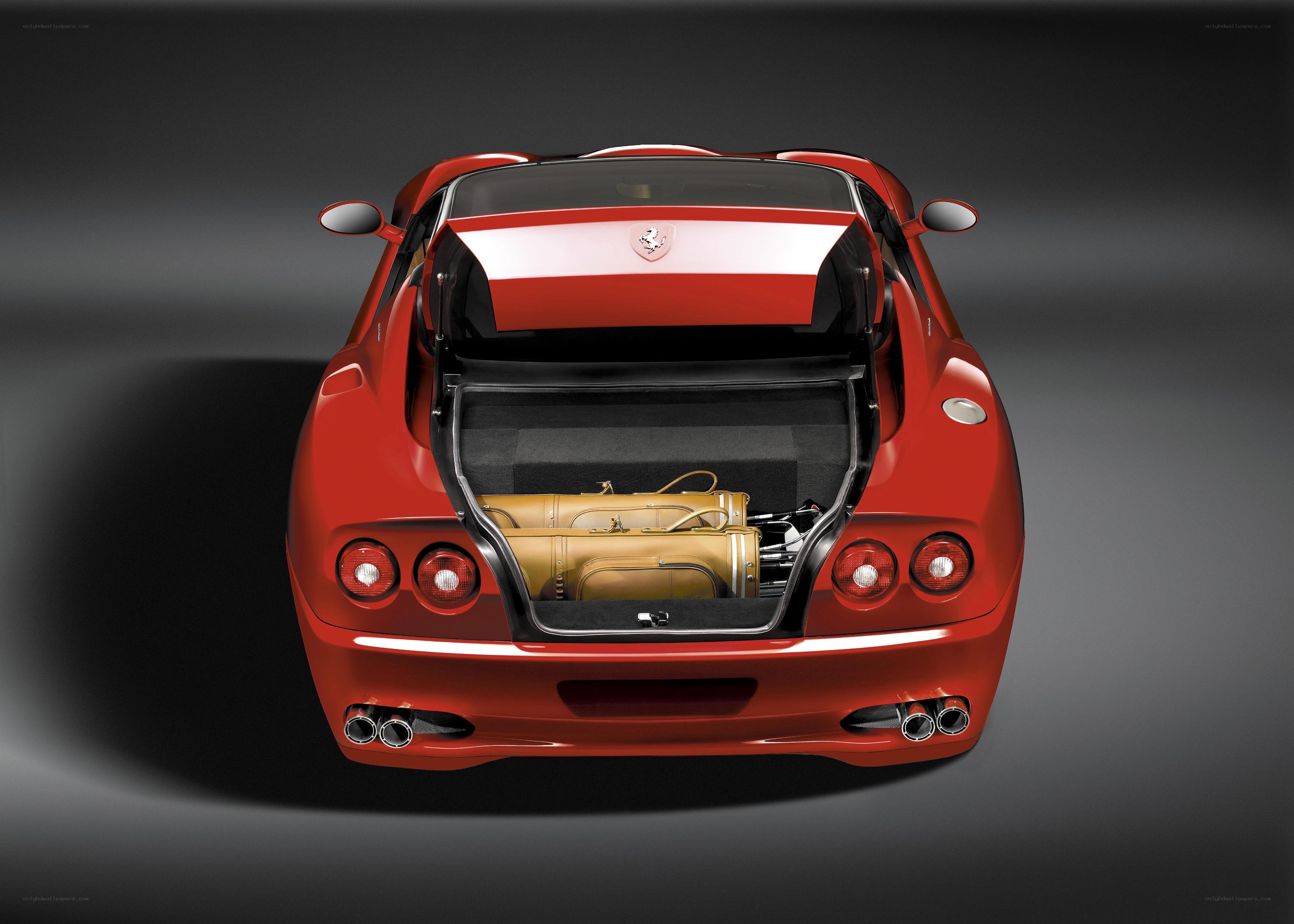 Red Ferrari with open trunk