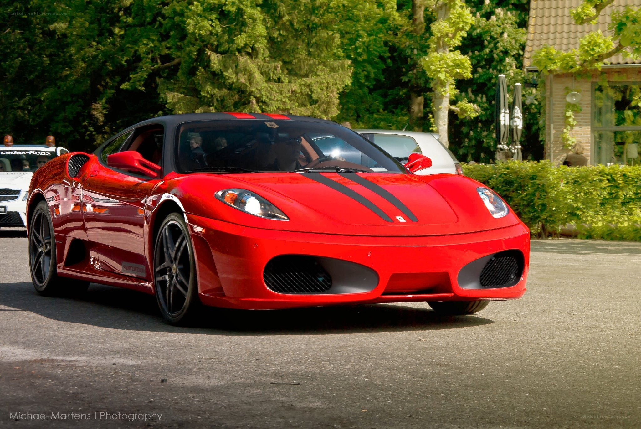 Red Ferrari with racing stripes