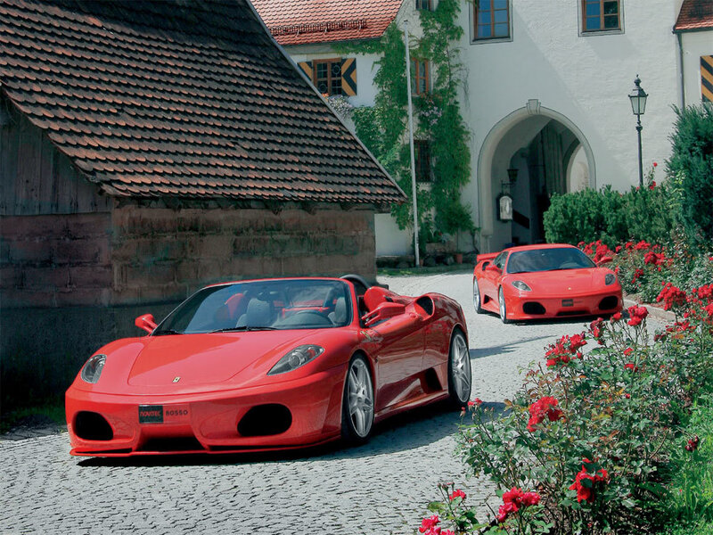 Red Ferraris in a courtyard
