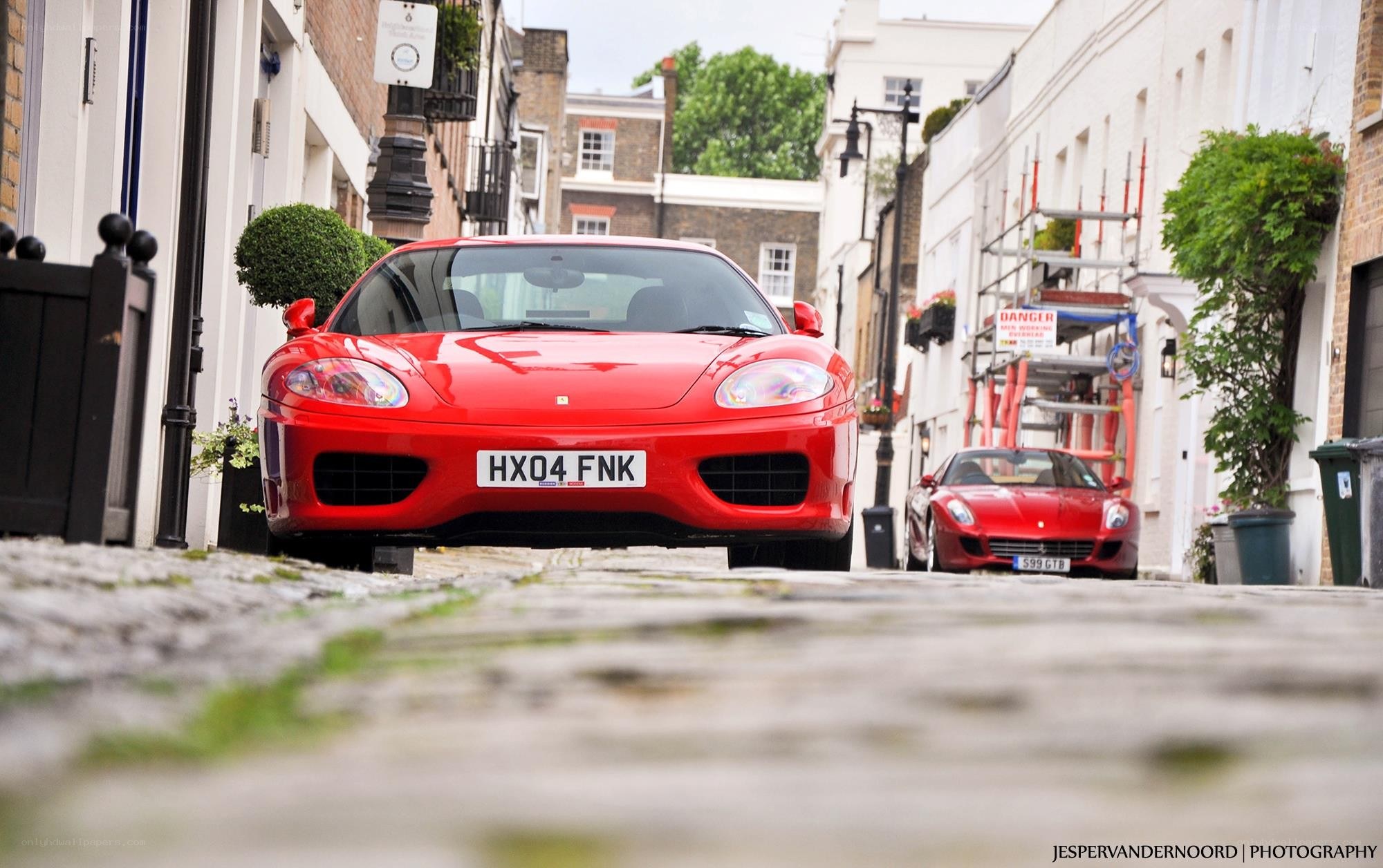 Red Ferraris on a cobblestone street