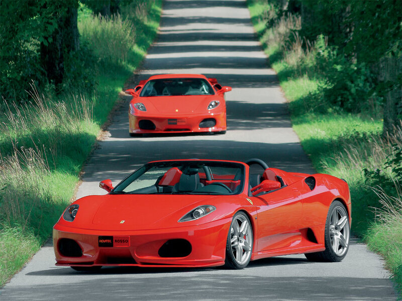 Red Ferraris on a country road