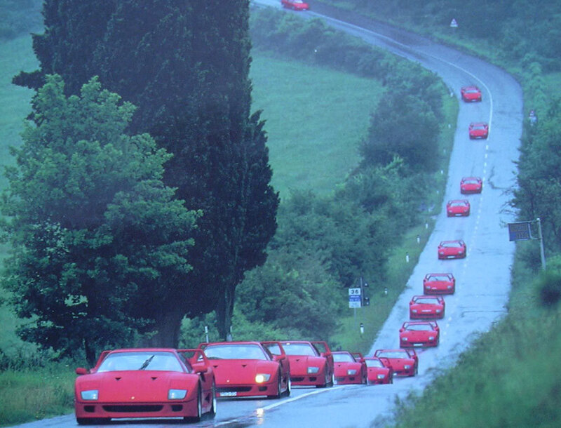 Red Ferraris on a winding road