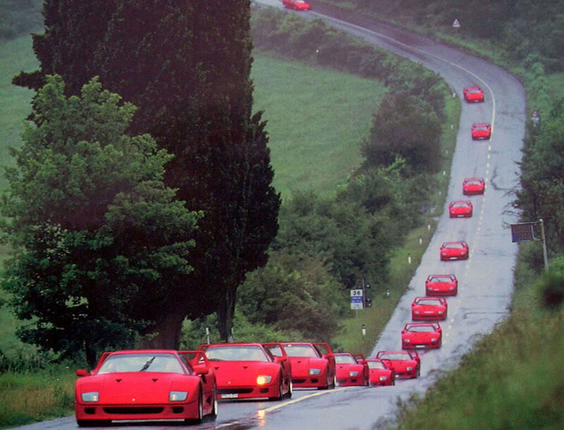 Red Ferraris on a winding road