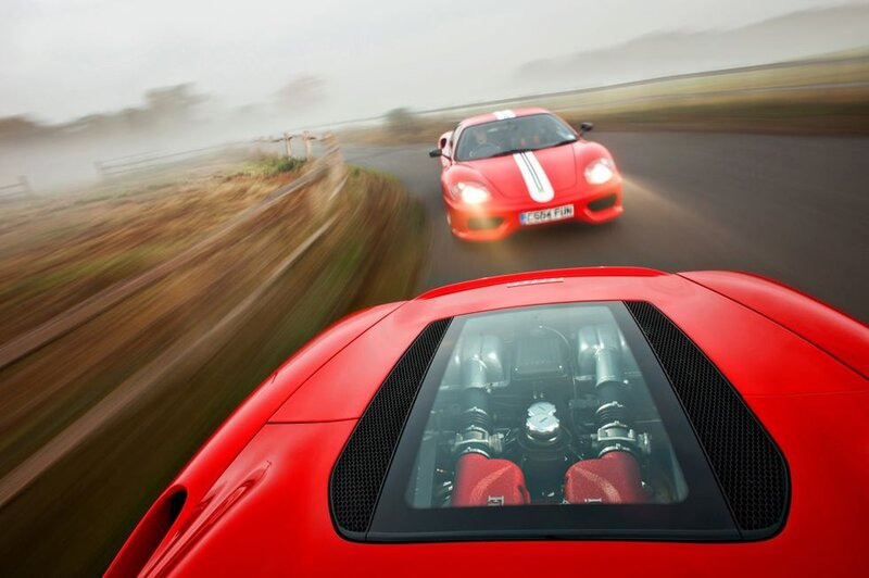 Red Ferraris racing on a track