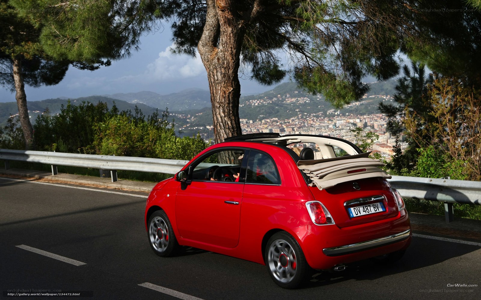 Red Fiat 500 Cabriolet on a scenic road
