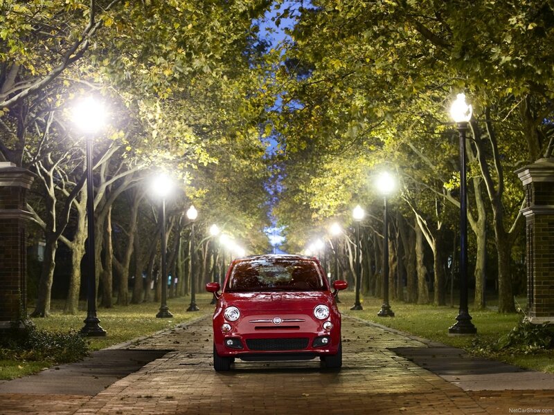 Red Fiat 500 on a tree-lined path