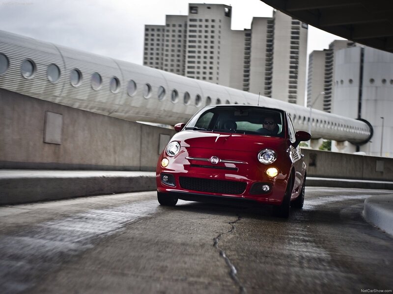 Red Fiat 500 on city overpass