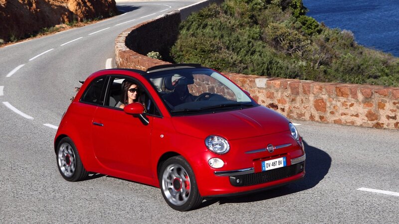 Red Fiat 500 on coastal road