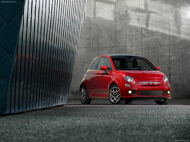 Red Fiat 500 parked in urban setting