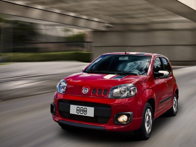 Red Fiat car in motion