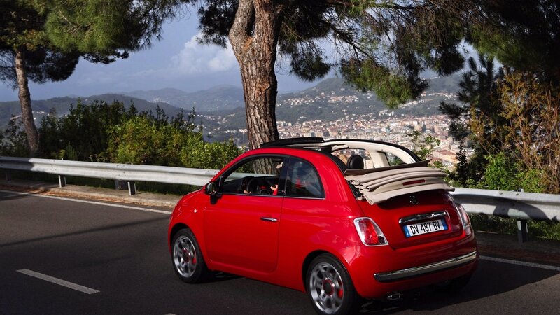 Red Fiat convertible on scenic road