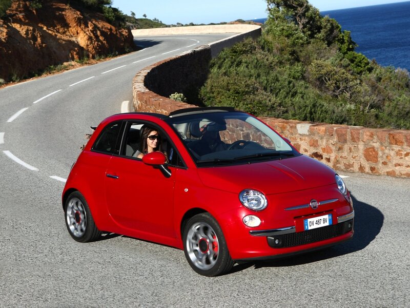 Red Fiat on coastal road