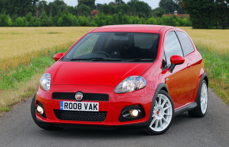 Red Fiat Punto parked on a country road