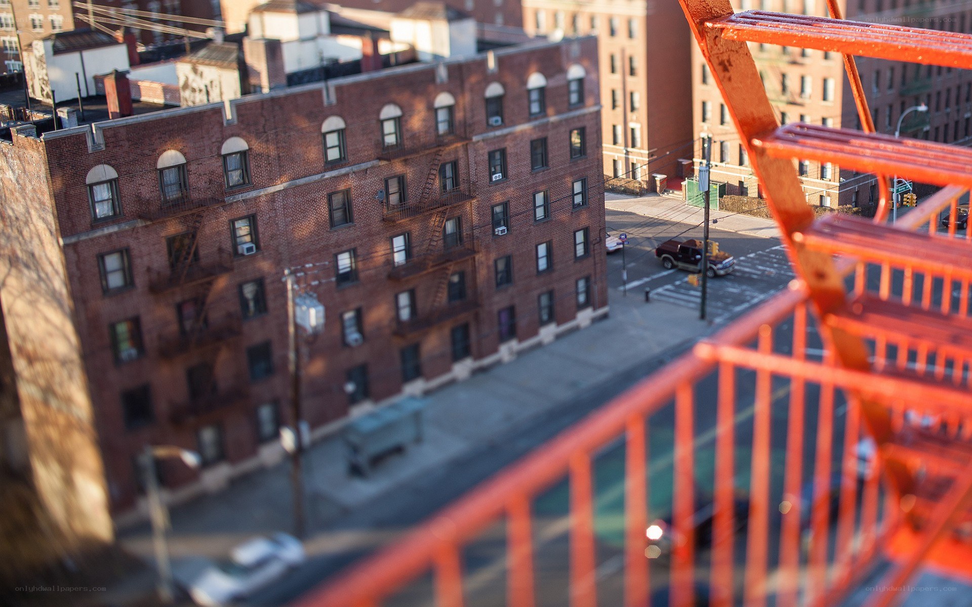 Red fire escape overlooking city street