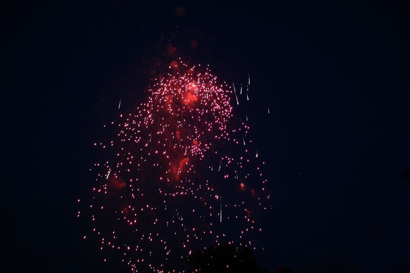 Red fireworks display at night