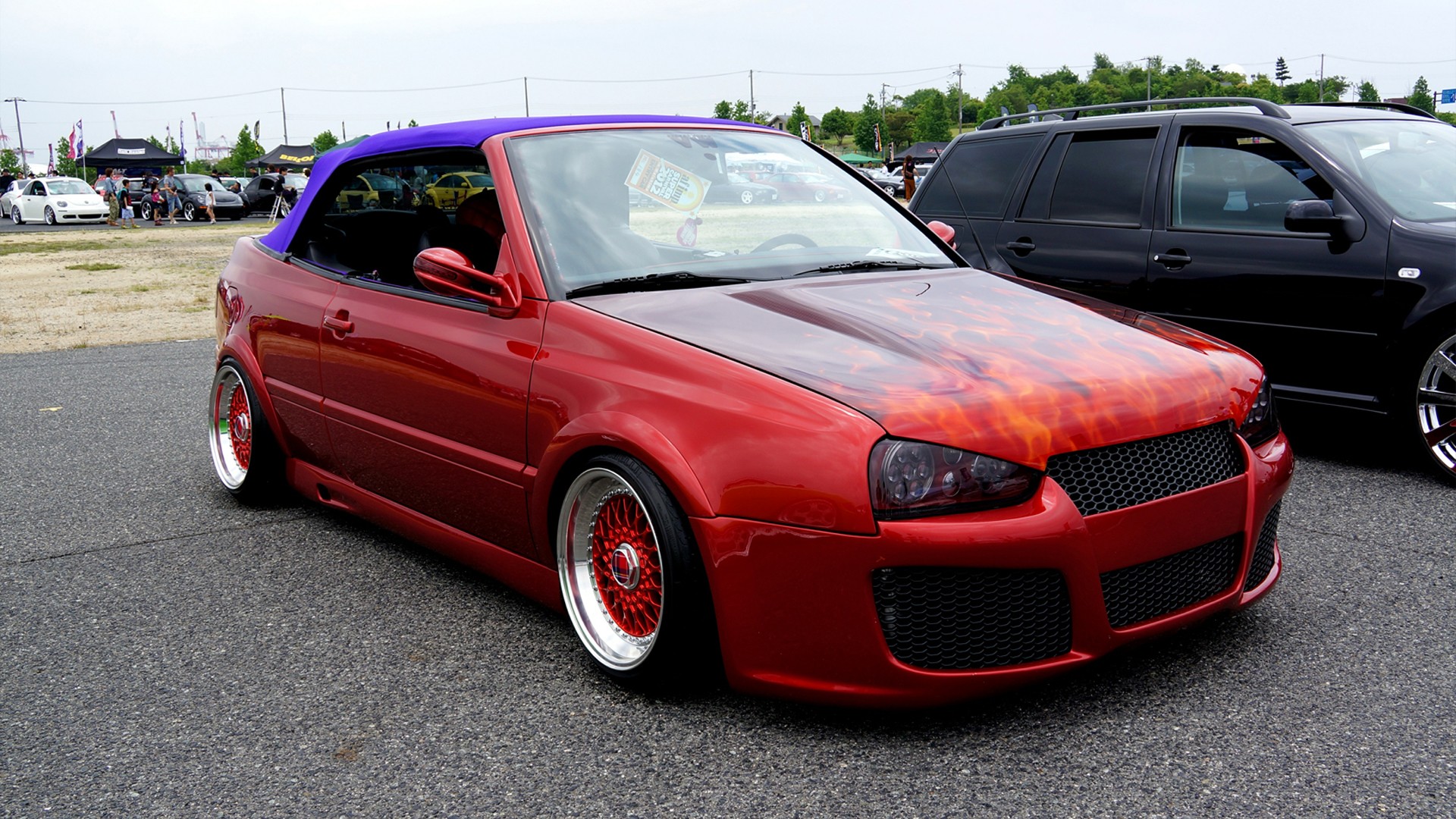 Red flame-painted convertible car