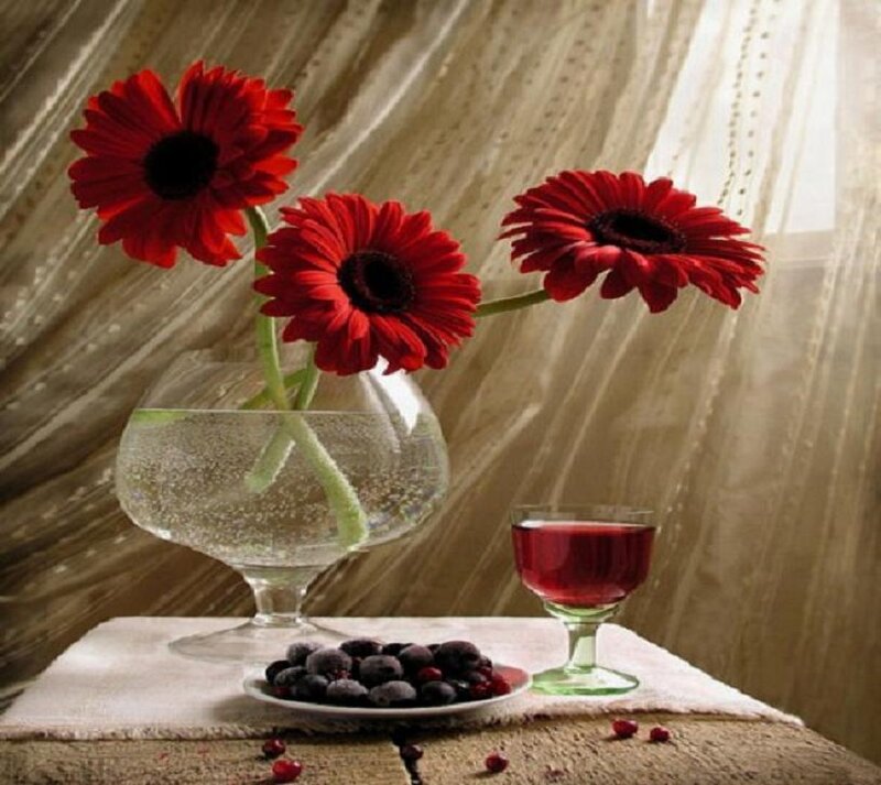 Red flowers and berries on table
