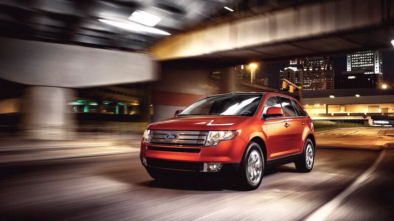Red Ford Escape in city at night